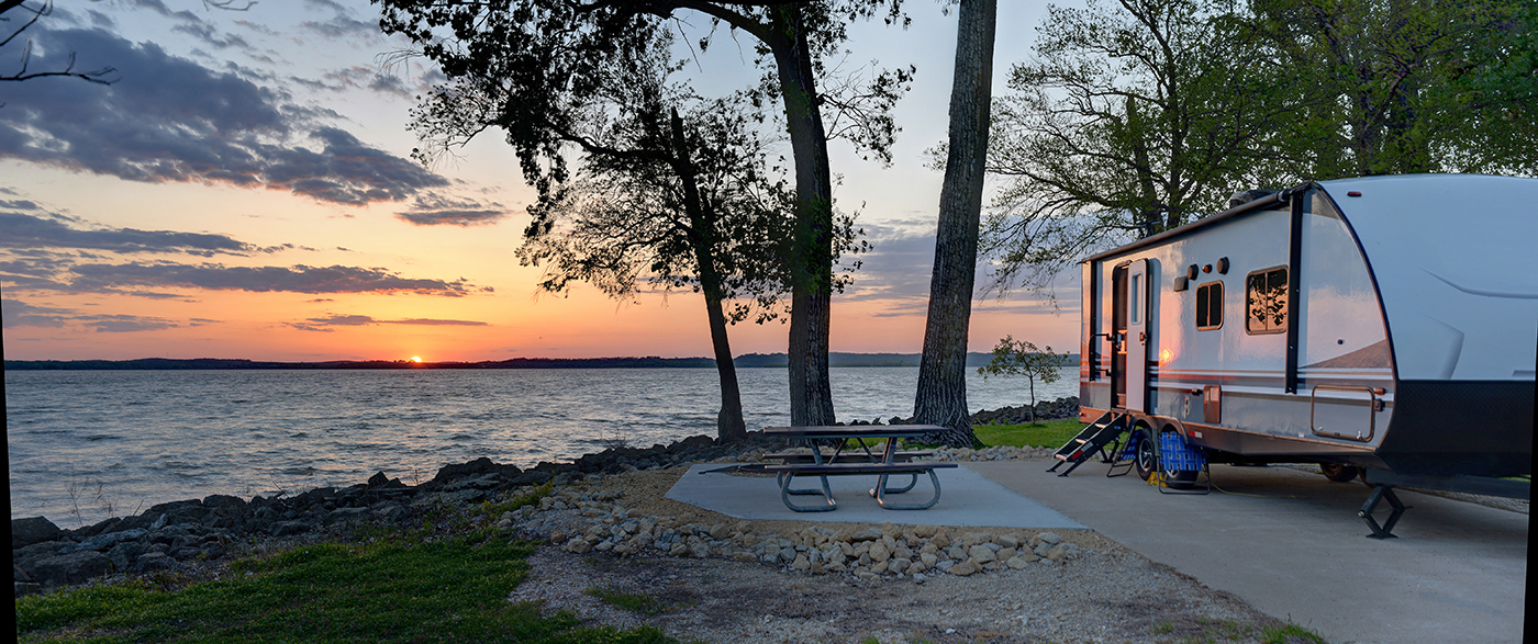 RV, by lake, during sunset