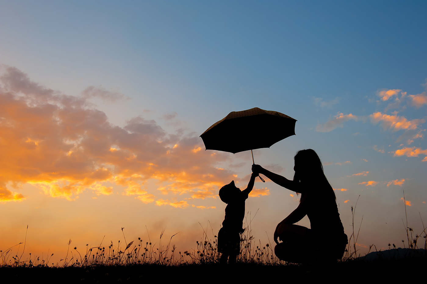 Mother and child holding umbrella